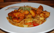 Fried Asian pasta with honey-chili chicken breast and vegetables