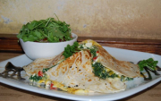Tortilla cooked with spinach, vegetables and cheese, with ruccola and tomato salad and jasmine rice