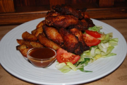 Buffalo chicken wings with ranchero sauce, home made French fries and fresh salad