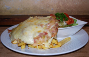 Turkey breast steak with Parma ham ragout and Parmesan,  served with French fries and fresh salad