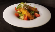 Roasted zander bites in parmesan cheescoat with  fresh salad and Roquefort sauce