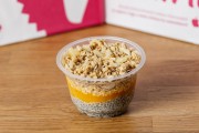 Chia pudding with peach jam, almond flakes and granola crunch