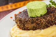Pepper-crusted grilled beefsteak with ruccola butter, fried onion mashed potatoe