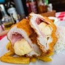 Ham and mozzarella-stuffed chicken breast breaded in panko crumbs, mixed garnish, Tartar sauce
