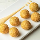 Fried, sticky rice ball with red beans, caramel and chocolate sauce