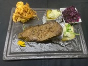 Texas steak with potatoes stuffed with spicy sheep's cheese and parsley salad with purple cabbage salad