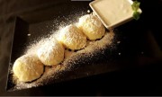 Cottage cheese dumplings rolled into toasted crumbs with cinnamon sour cream