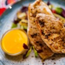 Grilled chicken breast with creamy cheddar sauce and grilled vegetables