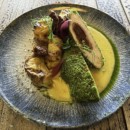 Chicken breast steak with aged ham and sun-dried tomatoes in green crumbs, truffle hollandaise sauce, gratin potatoes