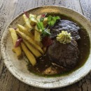 Rib-eye steak 230g, spiced butter, caramelized onion sauce, french fries